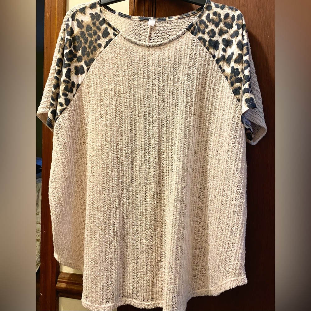 Plus size fashion Top. Solid beige body cheetah print sleeves.